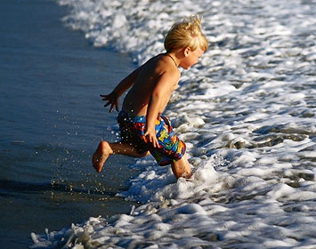 Child Running Into Surf